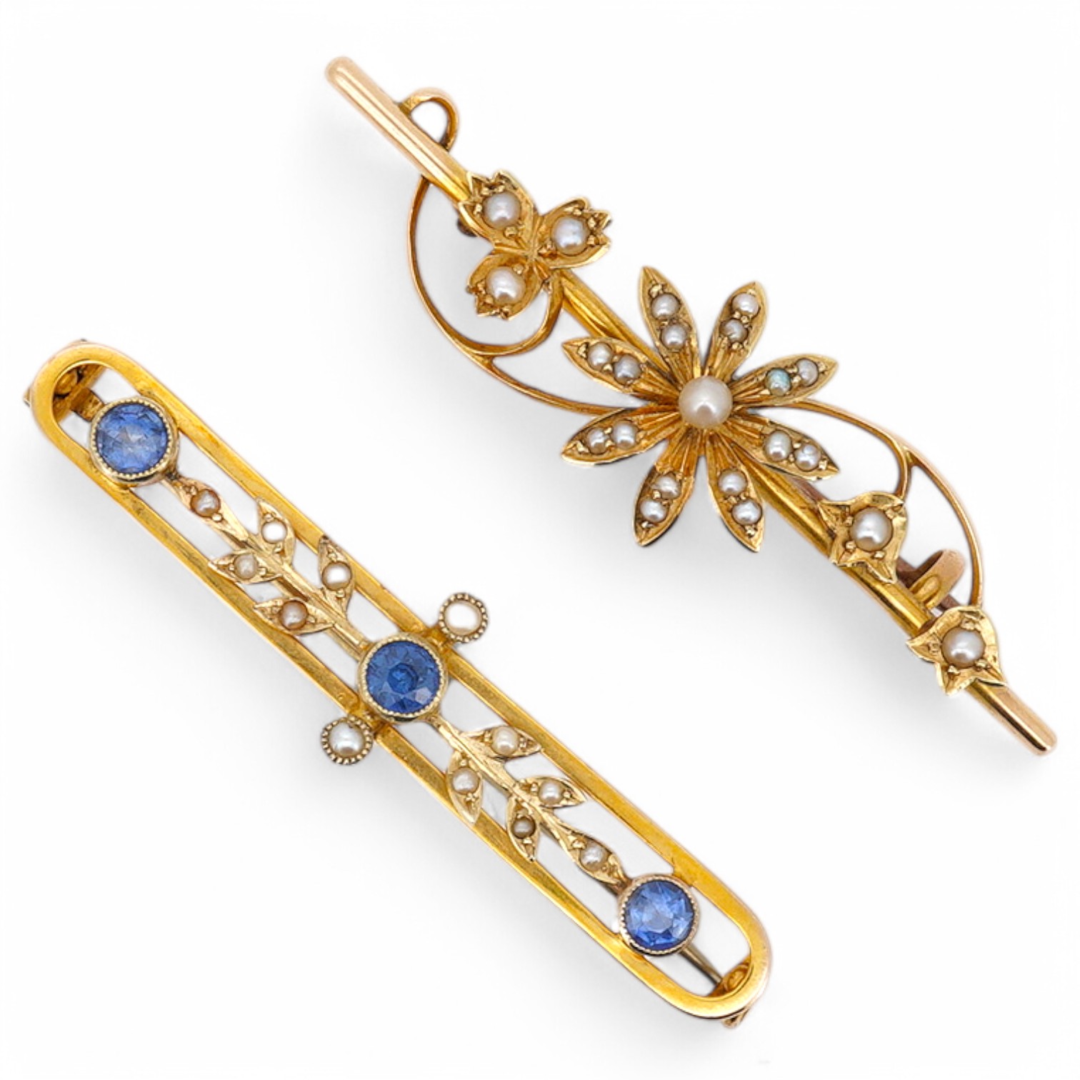 An Edwardian 9ct, sapphire and seed pearl set bar brooch, 43mm, gross weight 2.6 grams, together with a similar 15ct and seed pearl cluster set bar brooch, gross weight 2.9 grams. Condition - fair to good